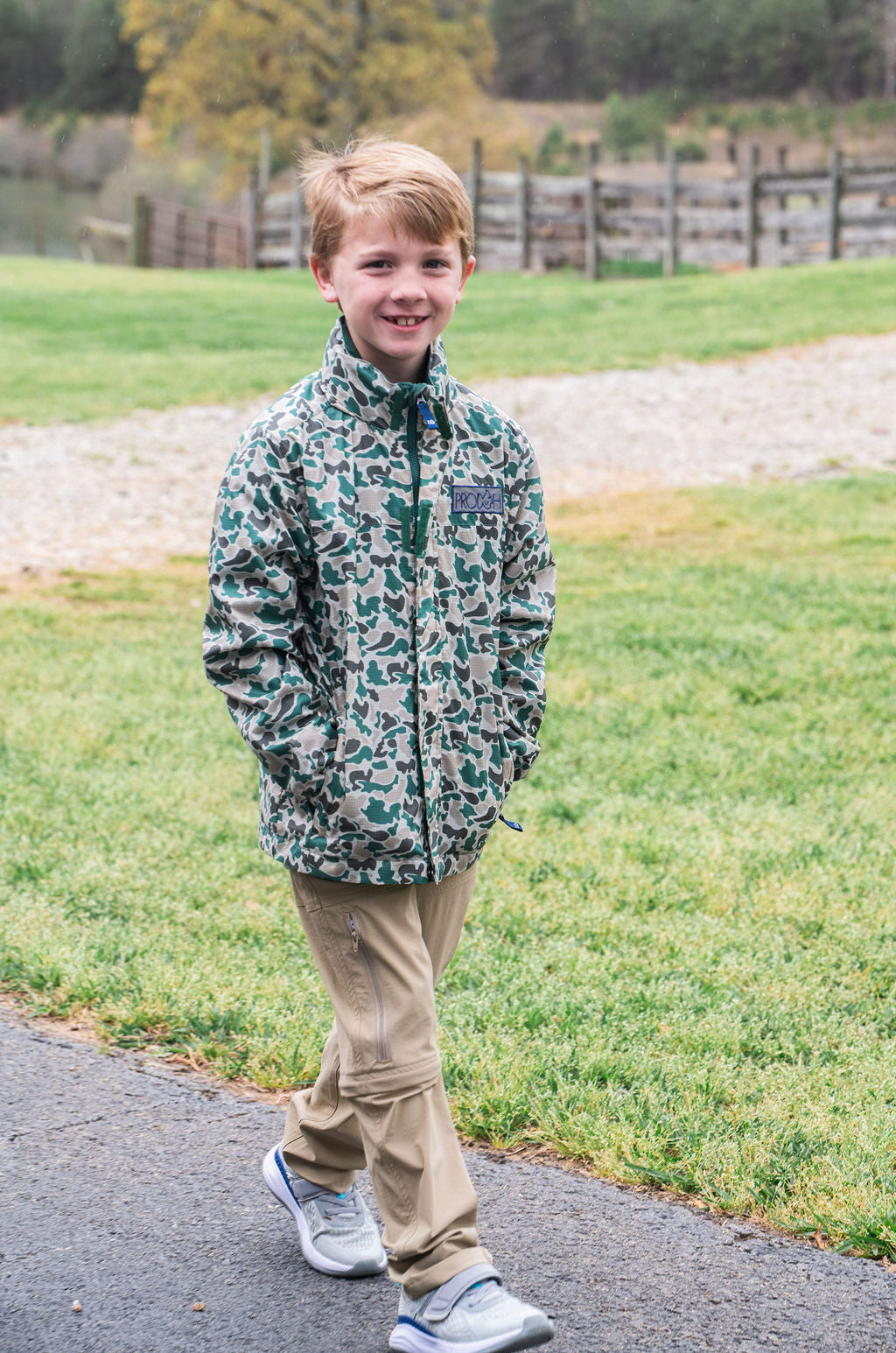 Neutral camo reflective rain jacket for toddlers and youth boys