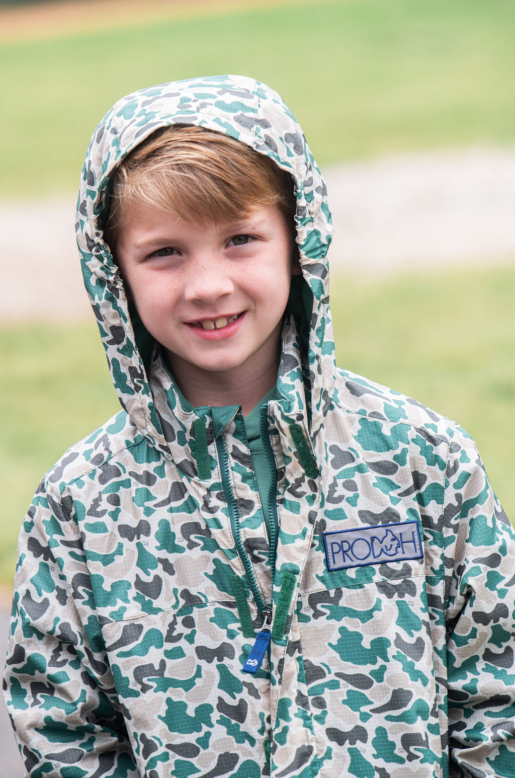 Boy in size L12/14 camo rain jacket for rainy weather