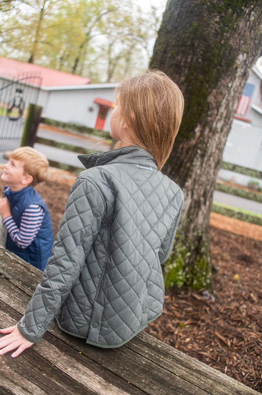 boys and girls green quilted jacket with snap and zip closure