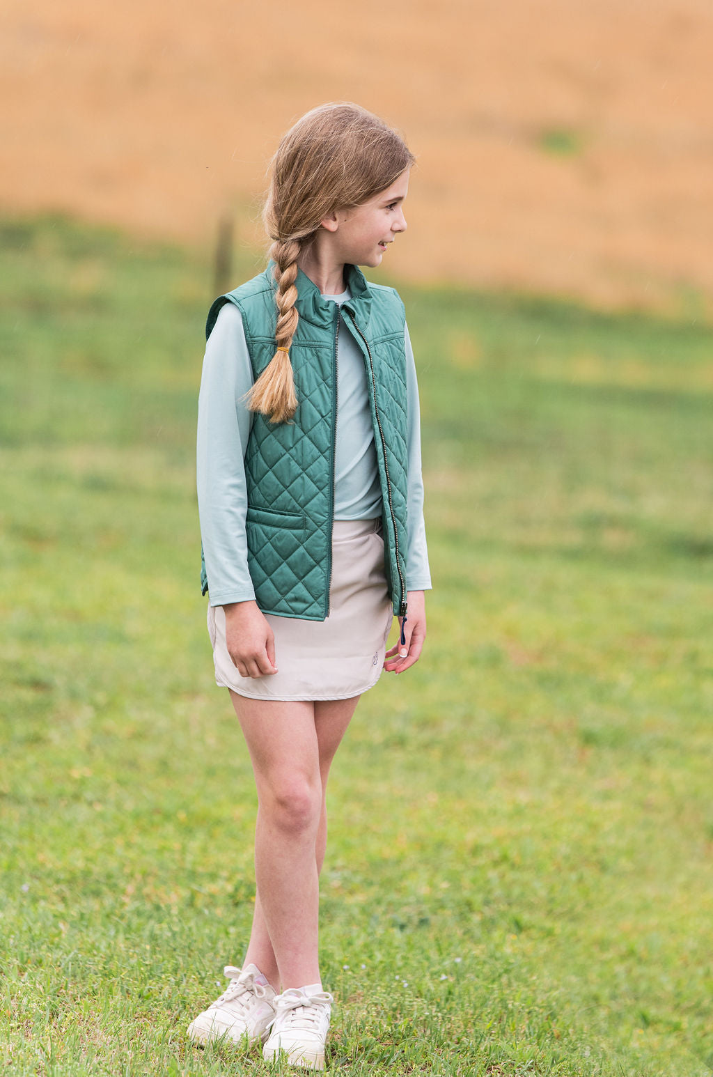 young girls wearing a green quilted vest