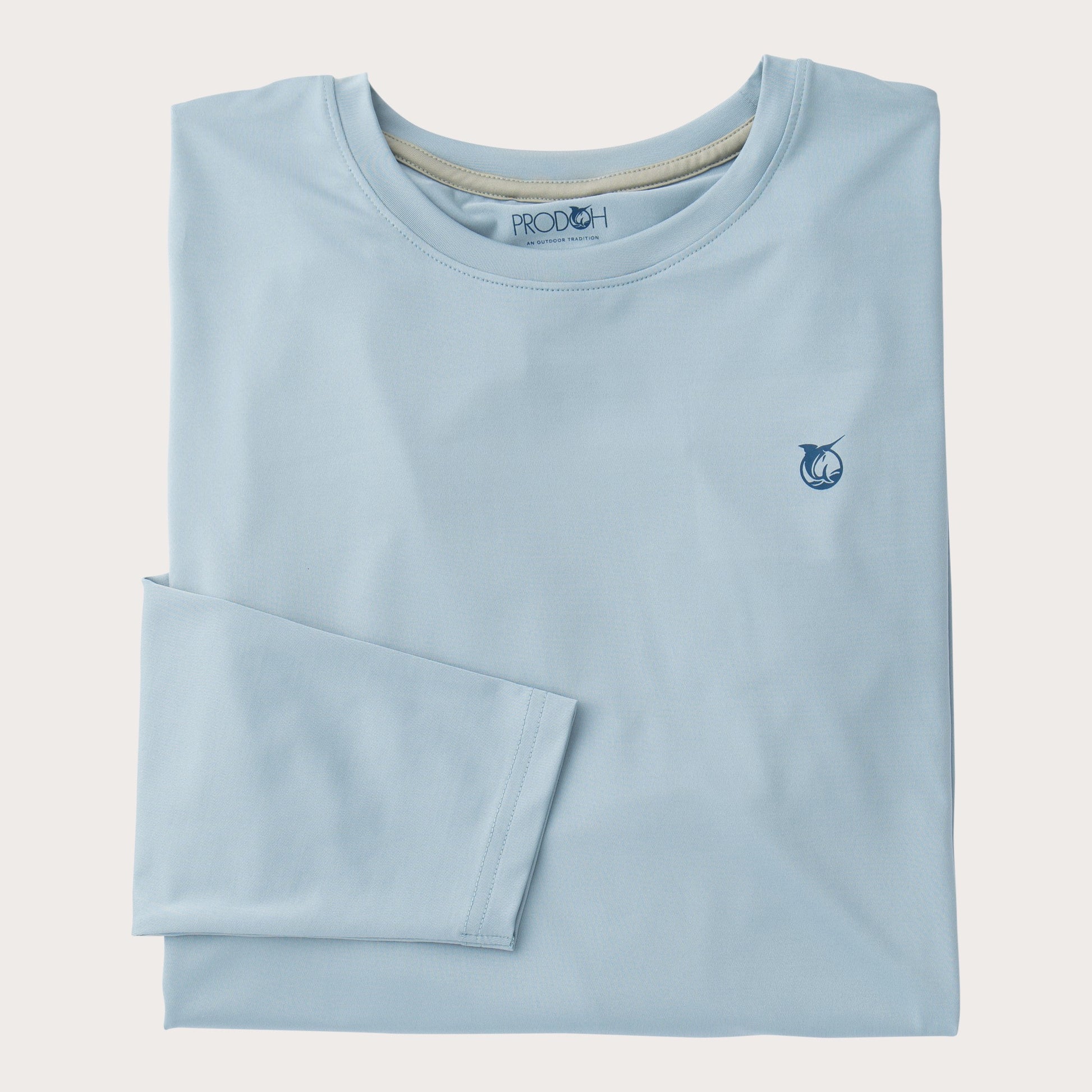 A light blue long-sleeve t-shirt by PROOCH, neatly folded with the left sleeve folded over the right, featuring a small navy blue fish logo on the left chest