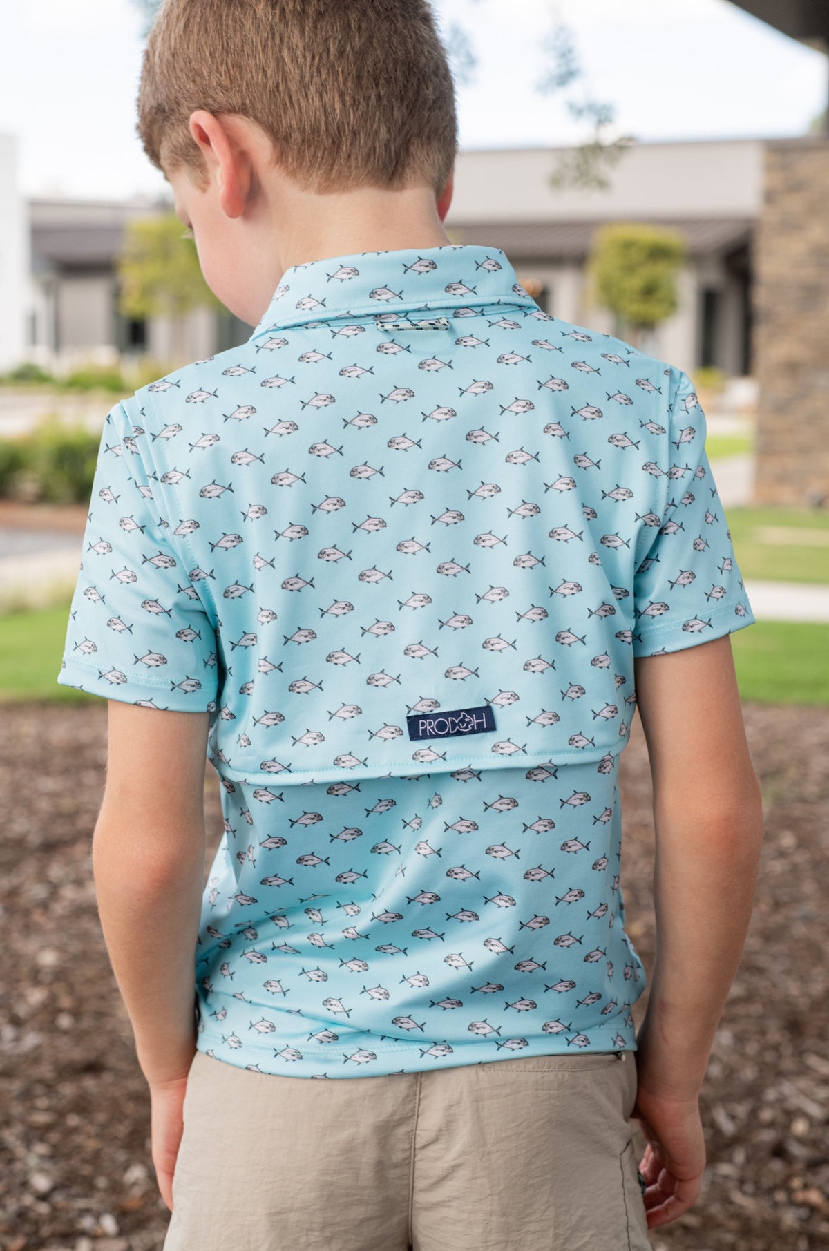 young boy wearing a light blue patterned shirt for school, play and outdoor activities