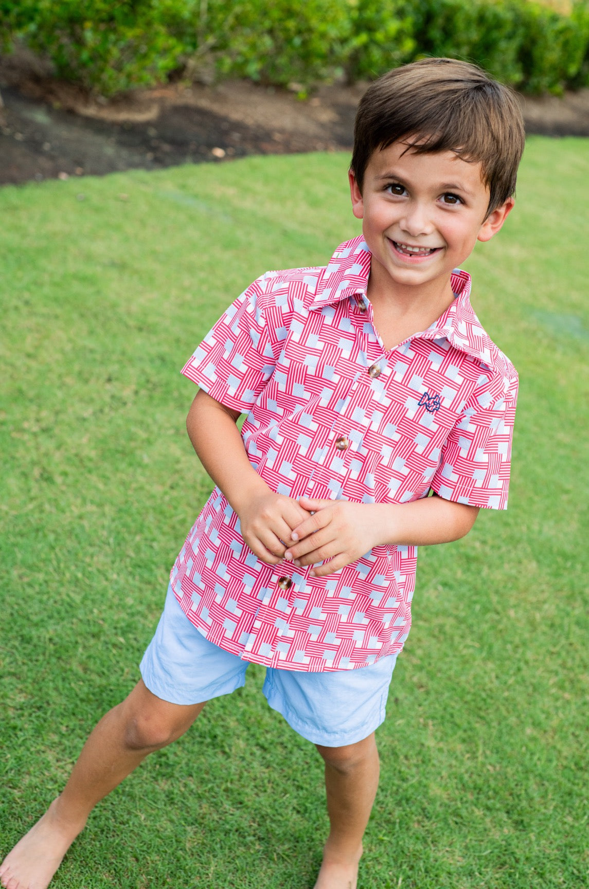 young boy wearing patriotic button up short sleeve shirt