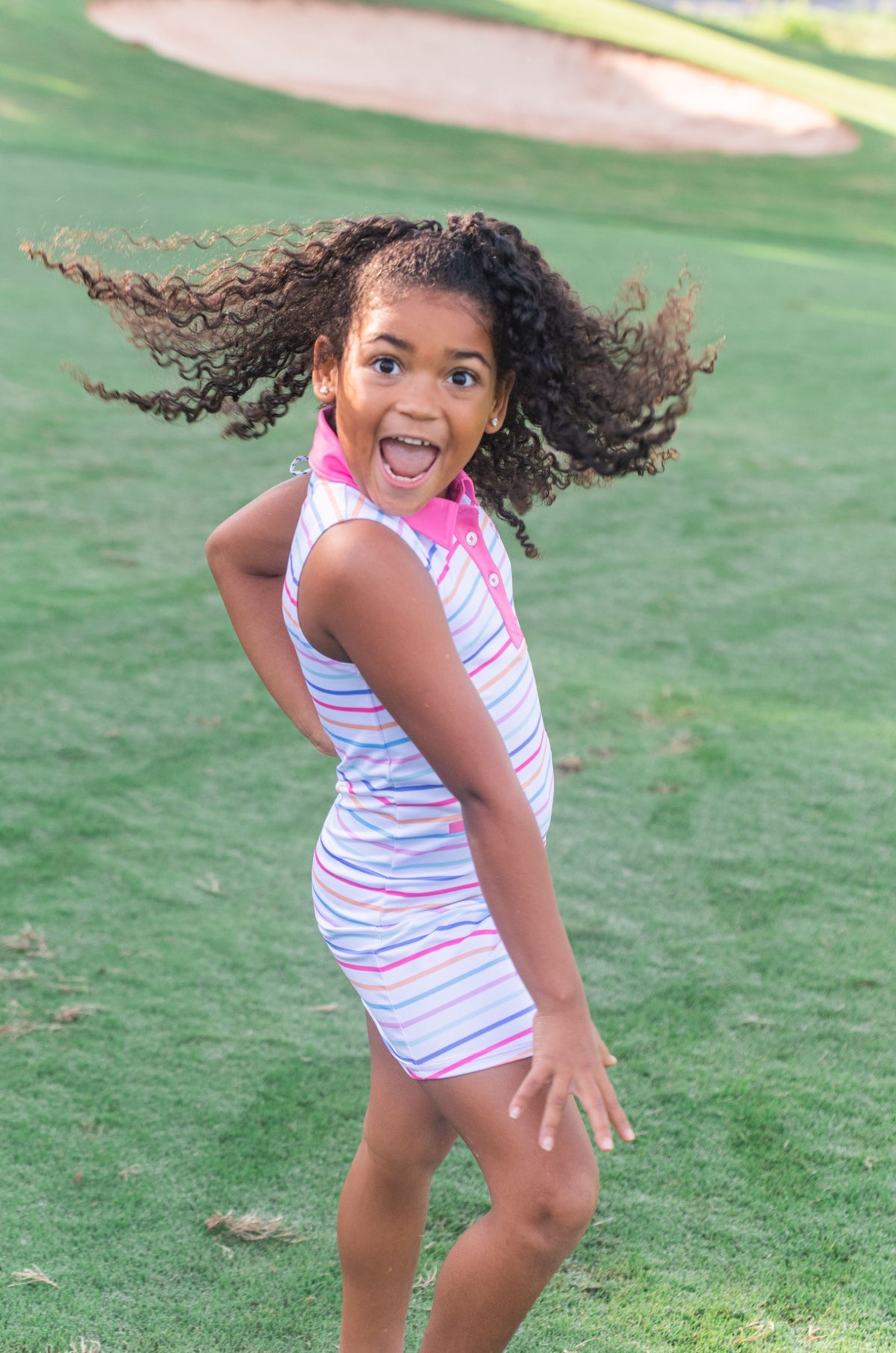 Young girl in a pink striped Sleeveless Polo Dress