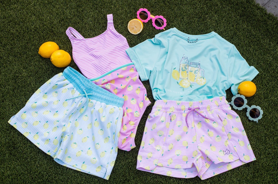Children's activwear set with shorts and tank top on grass