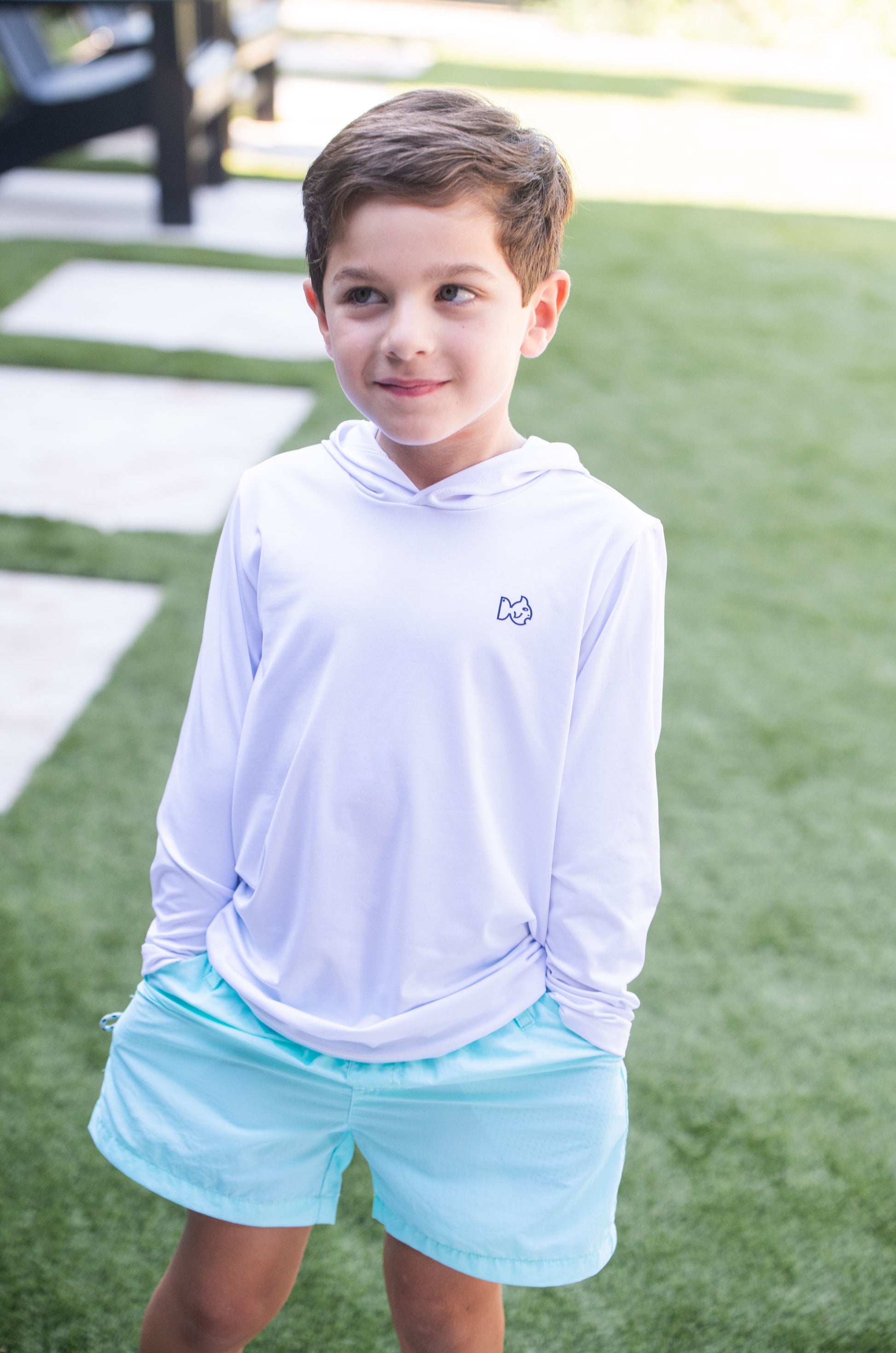Young boy wearing light blue performance shorts